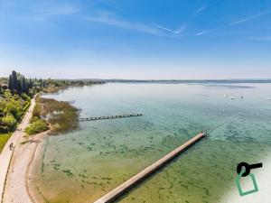 a large body of water with a pier in it at Hotiday Lazise Garda in Lazise