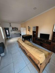 a large couch in a living room with a table at Depto Civora 2 in Villa Regina