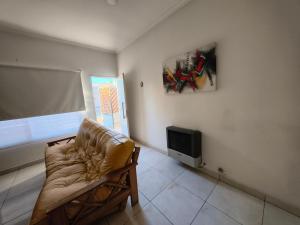 a living room with a couch and a tv at Depto Civora 2 in Villa Regina