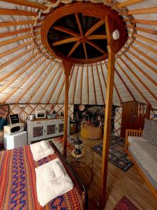 a room with a bed in a yurt at Rainbow's End Yurts in Dornoch