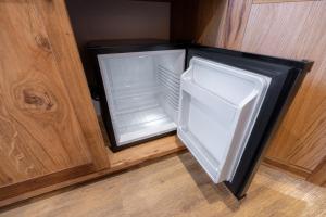 an empty refrigerator with its door open in a room at Bed & Breakfast LakeBled House in Bled