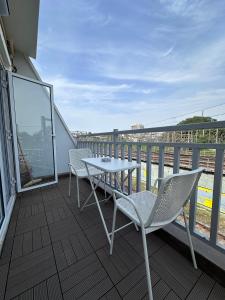 a patio with a table and chairs on a balcony at Rudraya Homes - Cozy Premium Serviced Apartments Khar - next to Bandra in Mumbai