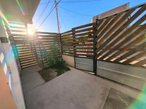 a balcony with a wooden fence on a building at Depto Civora 2 in Villa Regina