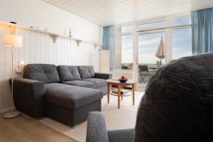 a living room with a couch and a table at StrandMöwe in Burgtiefe auf Fehmarn 