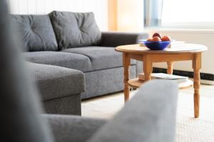 a living room with a table with a bowl of fruit on it at StrandMöwe in Burgtiefe auf Fehmarn 