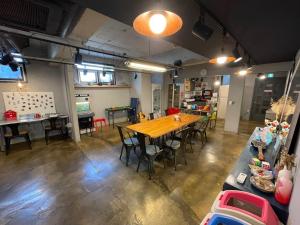 a large room with a wooden table and chairs at Suncheon Guest House Nreem in Suncheon