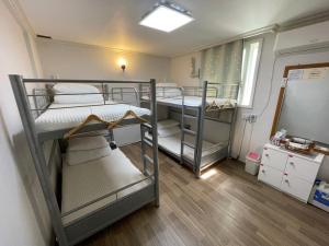 a small room with two bunk beds in it at Suncheon Guest House Nreem in Suncheon +12 photos