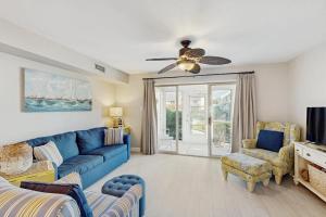 a living room with a blue couch and chairs at Sunset Village 31E in Ocean City