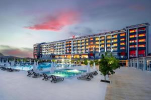 a hotel with a swimming pool and a building at Casa Fora Beach Resort Hotel - Spa & Aqua park - All Inclusive Plus Concept in Belek