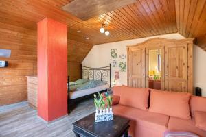 a living room with a couch and a bed at Toms Hütte in Udler