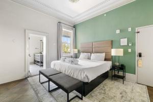 a bedroom with a large bed and a chair at King Suite 2nd FloorHotel Boutique in Savannah