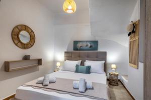 a bedroom with a bed with towels on it at Villa Angelo Porto Heli - Private Pool in Porto Heli +37 photos