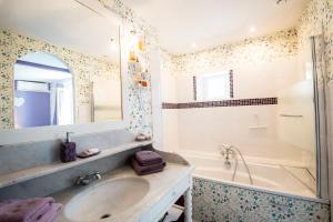a bathroom with a sink and a tub and a mirror at Le chant des oiseaux in Ryes +40 photos