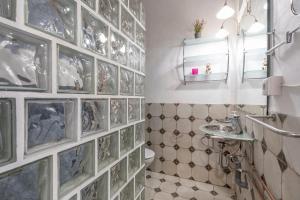 a bathroom with a tiled wall with pictures on it at Posada De Santiago in Rubite +24 photos