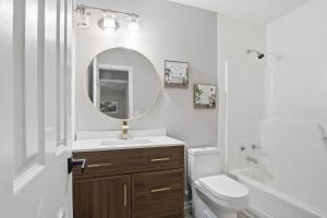 a white bathroom with a sink and a mirror at Elegant Modern Ranch Home in Atlanta +20 photos