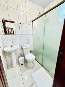 a bathroom with a toilet and a sink and a shower at Pousada H&D in Angra dos Reis +18 photos