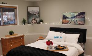 a bedroom with a bed with a tray of food on it at Nestled Inn Bed and Breakfast in Victoria