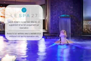 a woman in a swimming pool at a hotel at Westminster Hotel & Spa Nice in Nice