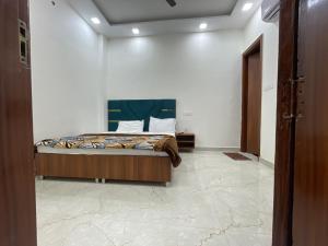 a bedroom with a bed in a white wall at Hotel 48 in Amritsar