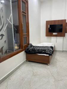 a small bed in a room with a window at Hotel 48 in Amritsar