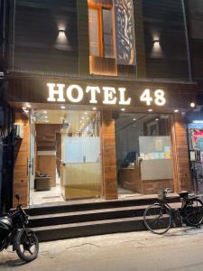 a hotel storefront with a bike parked in front at Hotel 48 in Amritsar