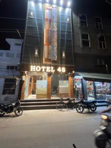 a hotel with bikes parked outside of it at night at Hotel 48 in Amritsar +2 photos