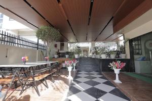 a restaurant with tables and chairs and a checkered floor at Mangalam Hotel and Restaurant in Lachhmangarh Sīkar