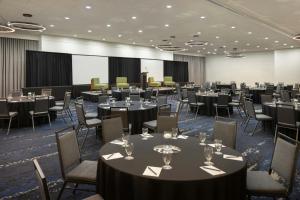 a conference room with tables and chairs and a podium at Courtyard by Marriott across Universal Orlando in Orlando +107 photos