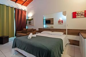 a hotel room with a bed and a couch at Jungle Beach Maresias in Maresias +33 photos