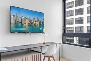 a desk with a television on a wall in a room at Downtown Miami Condo w Pool & Great Location in Miami