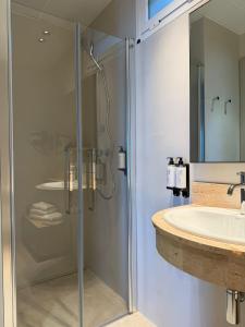 a bathroom with a shower and a sink at Hotel Restaurant Juanito Platja in Sant Carles de la Ràpita +56 photos