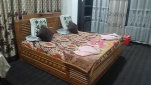 a bedroom with a wooden bed with pillows on it at Village guesthouse in Srinagar