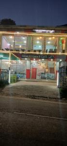 a building with a sign on the side of it at night at Village guesthouse in Srinagar