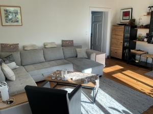 a living room with a couch and a table at Gästehaus Schinna in Stolzenau