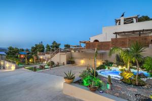 a house with a courtyard with a swimming pool at Villa Angelo Porto Heli - Private Pool in Porto Heli