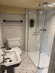 a bathroom with a shower and a sink and a toilet at The Unicorn, Ambleside in Ambleside +70 photos