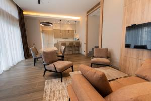 a living room with a couch and a table and chairs at Hotel Dilijan Resort in Dilijan