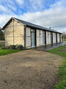 an old brick building with a lot of windows at Orangerie in Benais