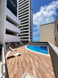 a swimming pool on the roof of a building at Flat Atlântico Neto in Fortaleza