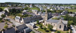 an aerial view of a small town with a church at Ker valou in Hénansal +2 photos