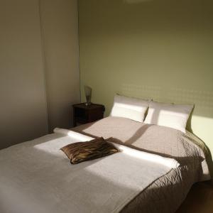 a bedroom with a bed with a robe on it at Ker valou in Hénansal