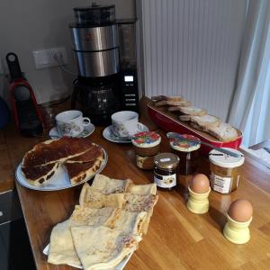 a table with pies and other food on it at Ker valou in Hénansal