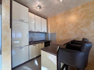 a kitchen with a counter and a table and chairs at Przno Sea Pearl - Seaview Holiday apartment in Pržno