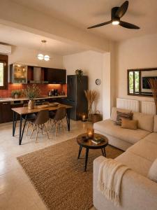 a living room with a couch and a table at Vitamin Sea Luxury Villas in Agia Pelagia