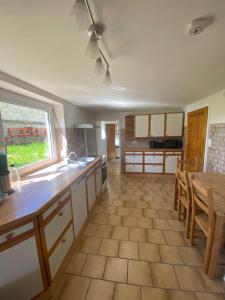 a large kitchen with a table and a window at M1 Appartement in Uttenweiler