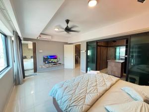 a bedroom with a large bed and a ceiling fan at Walnut Grove Premium Pool Villa in Batu Caves +23 photos