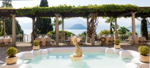 a fountain in a pool with a gazebo at Hotel Villa Cipressi, by R Collection Hotels in Varenna