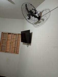a bike hanging from the ceiling of a room at Hotel Kairós in Campinas