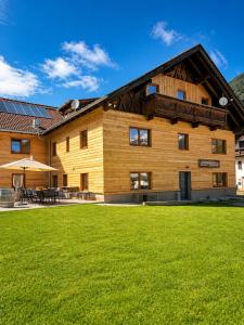 a house with a lawn in front of it at Alpenhaus Bichlbach in Bichlbach