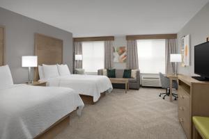 a hotel room with two beds and a flat screen tv at Holiday Inn Santee by IHG in Santee